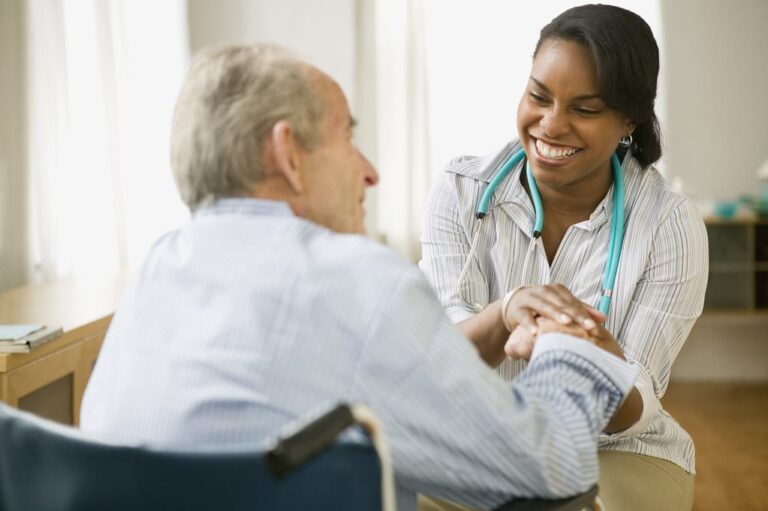 Speech therapist holding of senior man in a wheelchair.