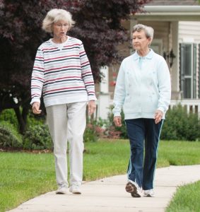 Two Carroll Lutheran Village female residents walking on the sidewalk through our Weller neighborhood.