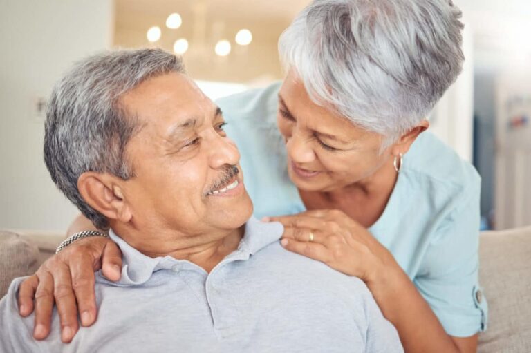 A senior couple looking happy at each other after deciding if nursing homes or senior living communities are the right solution for them.