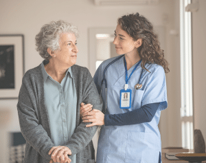 Nurse assisting older women.