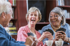 Three older adults laughing.