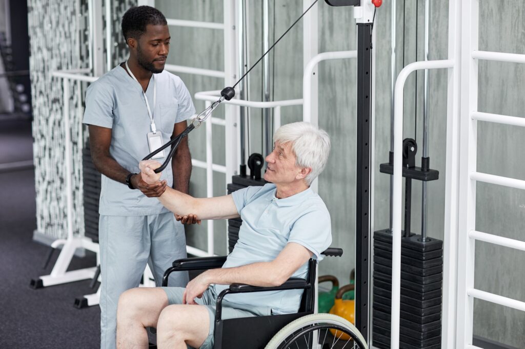 Senior Man using Wheelchair in Rehabilitation Gym
