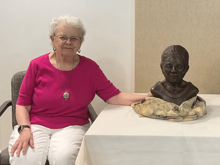 Martha Wiseman with bust of Mae E. Prince